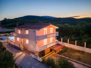 a house with a view of the sunset at Vacation villa Matic with 7 bedrooms in Sinj
