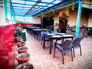 a row of tables and chairs in a restaurant at Hotel Crystal Palace in Mussoorie