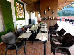 a restaurant with a table and chairs in a room at Hotel Crystal Palace in Mussoorie +16 photos