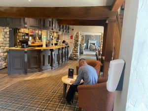 a man sitting at a table in a bar at 4 lakes holiday let in Carnforth