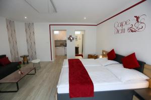 1 dormitorio con 1 cama blanca grande con manta roja en EHM Resort Mesteri, en Mesteri
