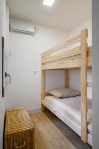 a bedroom with a bunk bed with a wooden bunk ladder at Magnifique appartement plein centre, calme, Netflix in Mirepoix