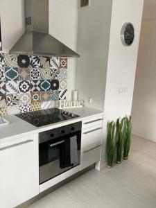 a kitchen with a stove top oven next to a sink at Apartament Sobieskiego in Zabrze