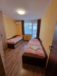 a room with two beds and a window at Apartment Lozenets in Sofia