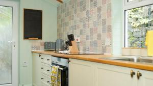 a kitchen with a counter top and a sink at Hawthorn Cottage in Uig