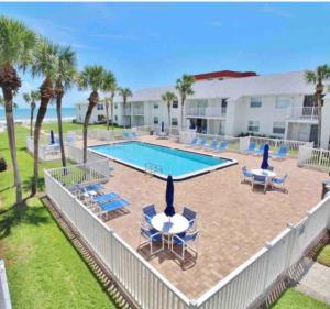 an image of a swimming pool at a resort at Beachfront Serenity Private Balcony with Ocean View, Shared Heated Pool and BBQ in New Smyrna Beach