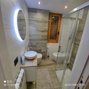 a bathroom with a sink and a mirror and a shower at Casa di Nastya in Pretoro +12 photos