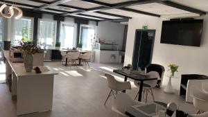 a large room with tables and chairs and a tv at Hotel Schneider-Hof in Bad Salzuflen