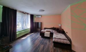 a bedroom with two beds and a large window at Apartment Lozenets in Sofia