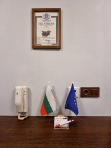 a wall with a phone and flags on a table at Apartment Lozenets in Sofia +11 photos