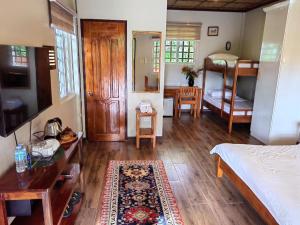 ein Schlafzimmer mit einem Bett und ein Wohnzimmer mit einem Bett m2 in der Unterkunft Blue Raven Resort in Anda
