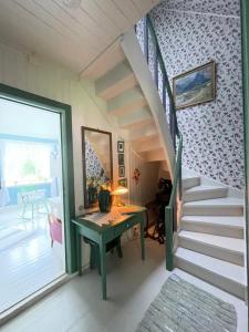 a staircase in a house with a desk and a stair case at Aobrio Holidayhouse, old farmhouse close to Flåm in Lærdalsøyri