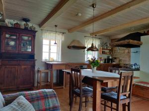 a kitchen with a table and chairs in a room at Hansi Puhkemaja in Kuivastu