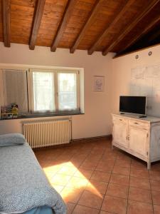 a living room with a bed and a television at Casetta di Chri in Chiavari