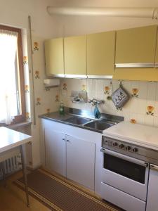 a kitchen with white cabinets and a sink at Casa Ezio - Piano terra in Malesco