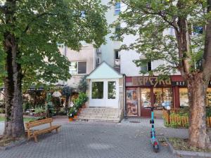 a store with a bench in front of a building at Apartment Lozenets in Sofia