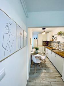 a kitchen with a table and a dining room at Central Palace Suites with Parking in Iaşi