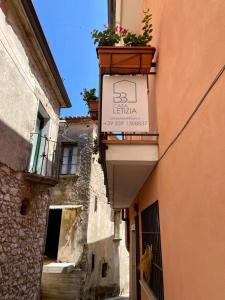 an alley with a sign on the side of a building at B&B Casa Letizia in Trentinara