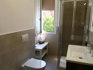 a bathroom with a shower and a toilet and a sink at Casa di Babi in Verona