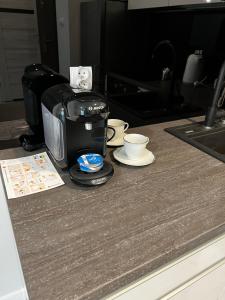 a toaster sitting on a counter with a coffee maker at Apartment Comfort in Bartoszyce
