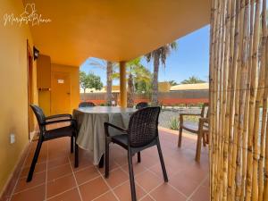 ein Esszimmer mit einem Tisch und Stühlen auf einer Terrasse in der Unterkunft B-Rent Mariposa Private Garden in Corralejo