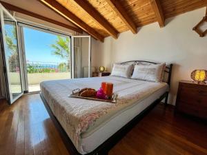 a bedroom with a bed with a tray of food on it at Giovanni Group Apartments in Syvota