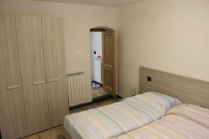 ein Schlafzimmer mit einem Bett und einem Schrank in der Unterkunft appartamento in piccolo borgo immerso nel verde in Castiglione Chiavarese