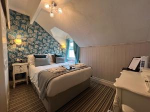 a bedroom with a bed and a piano in a room at Delovely Hotel in Blackpool