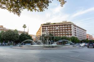 a fountain in the middle of a city with a building at 7th floor apartment in Foggia