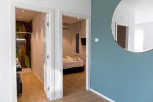 a hallway with a mirror and a room with a bed at 7th floor apartment in Foggia