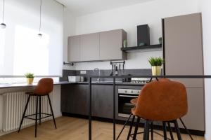 a kitchen with a table and two chairs in it at 7th floor apartment in Foggia