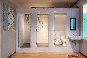 a bathroom with a shower and a toilet and a sink at Buri Hostel Bangkok in Amphoe Phra Khanong