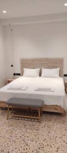 a bedroom with a large bed with white sheets and pillows at Casa Manny in Rhodes Town