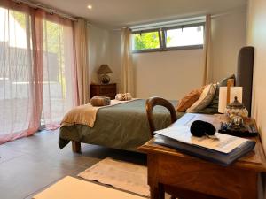 a bedroom with a bed and a desk with a book at Vexin Studio in Chaumont-en-Vexin
