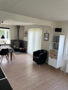 Sala de estar con silla negra y mesa en Holiday home Als en Augustenborg