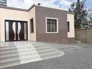 a house with stairs leading up to a door at 401 Restaurant & Accommodation in Naivasha