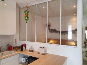 a kitchen with a counter with a toaster and a sink at Suquet 22 – 2 Pièces, Cannes Cœur Historique, Calme, Plage à 300m, Parking in Cannes