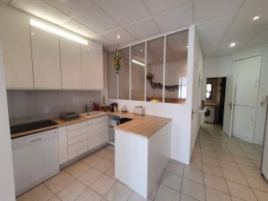 a kitchen with white cabinets and a counter top at Suquet 22 – 2 Pièces, Cannes Cœur Historique, Calme, Plage à 300m, Parking in Cannes