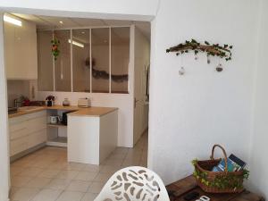 a kitchen with white cabinets and a counter top at Suquet 22 – 2 Pièces, Cannes Cœur Historique, Calme, Plage à 300m, Parking in Cannes +33 photos