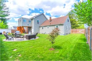 a house with a yard with a table and a fence at RI Full House - Gym, Entertain & More in Cranston