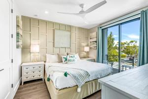 a bedroom with a bed and a balcony at Shore Thing in Sarasota