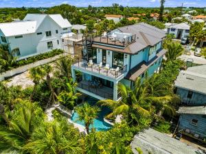 an aerial view of a house with a pool and palm trees at Shore Thing in Sarasota
