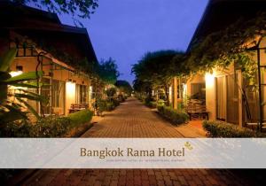 a cobblestone street in a resort at night at Bangkok Rama Hotel in Bangkok