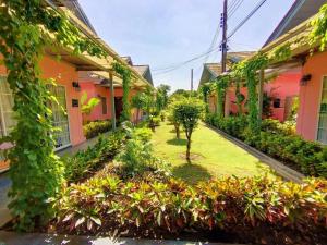 a courtyard of a house with plants and trees at Bangkok Rama Hotel in Bangkok