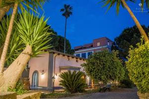 a building with palm trees in front of it at Villetta Capodimonte in Naples