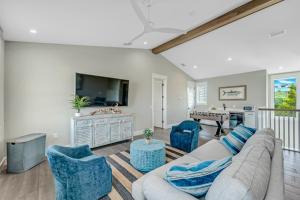 a living room with a couch and chairs and a television at Shore Thing in Sarasota