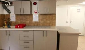 a kitchen with white cabinets and a counter top at Vila Arthur in Eforie Nord