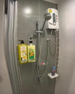 a shower in a bathroom with a blow dryer at Stunning Seaview Suite in Jomtien Beach