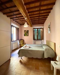 a bedroom with a large bed in a room at Casa Toscanella & Girasole in Pescia