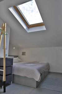 a bedroom with a bed and a skylight at Villa Klara in Vodice